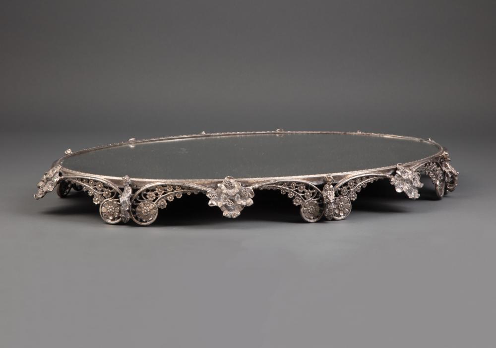 Appraisal: Decorative Silvered Bronze Mirrored Plateau oval mirror plate scroll feet