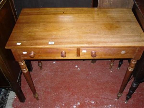 Appraisal: A two drawer side table on turned supports