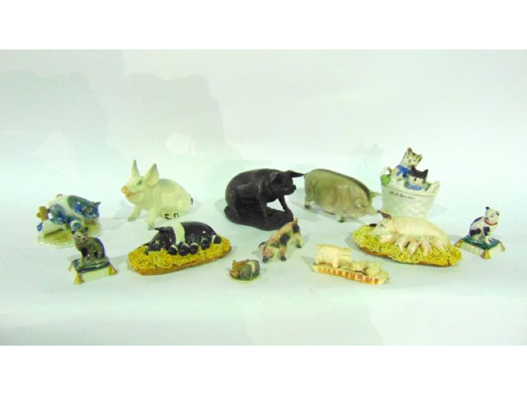 Appraisal: A collection of ceramic and other models of pigs including