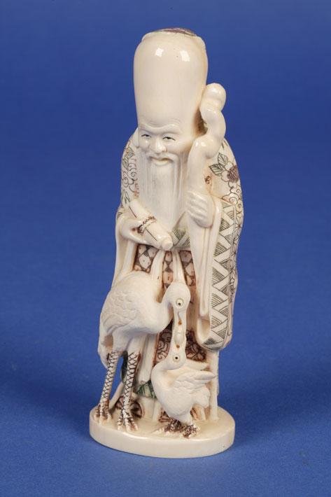 Appraisal: A JAPANESE IVORY FIGURE of an immortal holding a staff