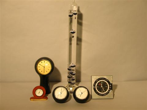 Appraisal: GROUP OF CLOCKS AND THERMOMETERS Comprising a glass Galileo cyclindrical