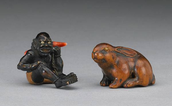 Appraisal: An ebonized wood and coral figural study Depicting a South