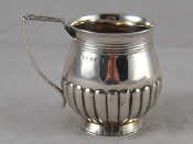 Appraisal: A Georgian silver christening cup of half ribbed bellied form