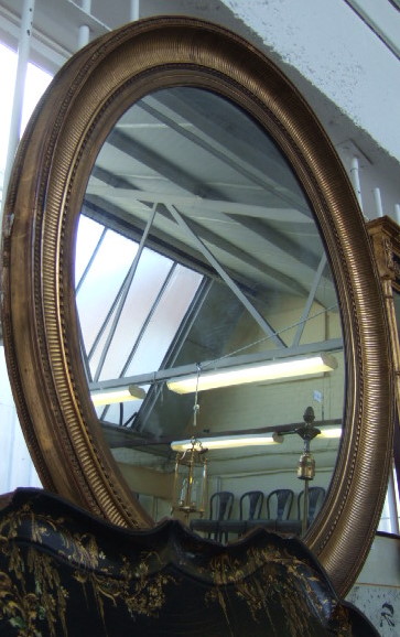 Appraisal: A large gilt gesso wall mirror with a fluted frame