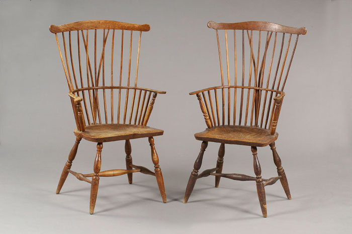 Appraisal: UNUSUAL PAIR OF BRACE-BACK WINDSOR ARMCHAIRS Each with a slightly