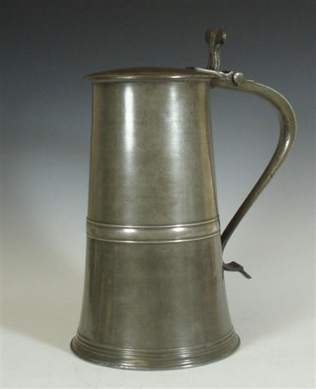 Appraisal: A Scottish flat lidded pewter flagon of tapered cylindrical form