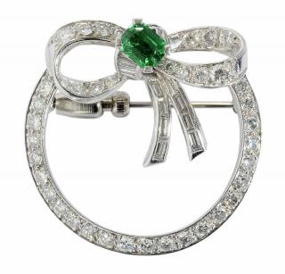 Appraisal: Platinum and Diamond Circle Brooch with bow accent set with