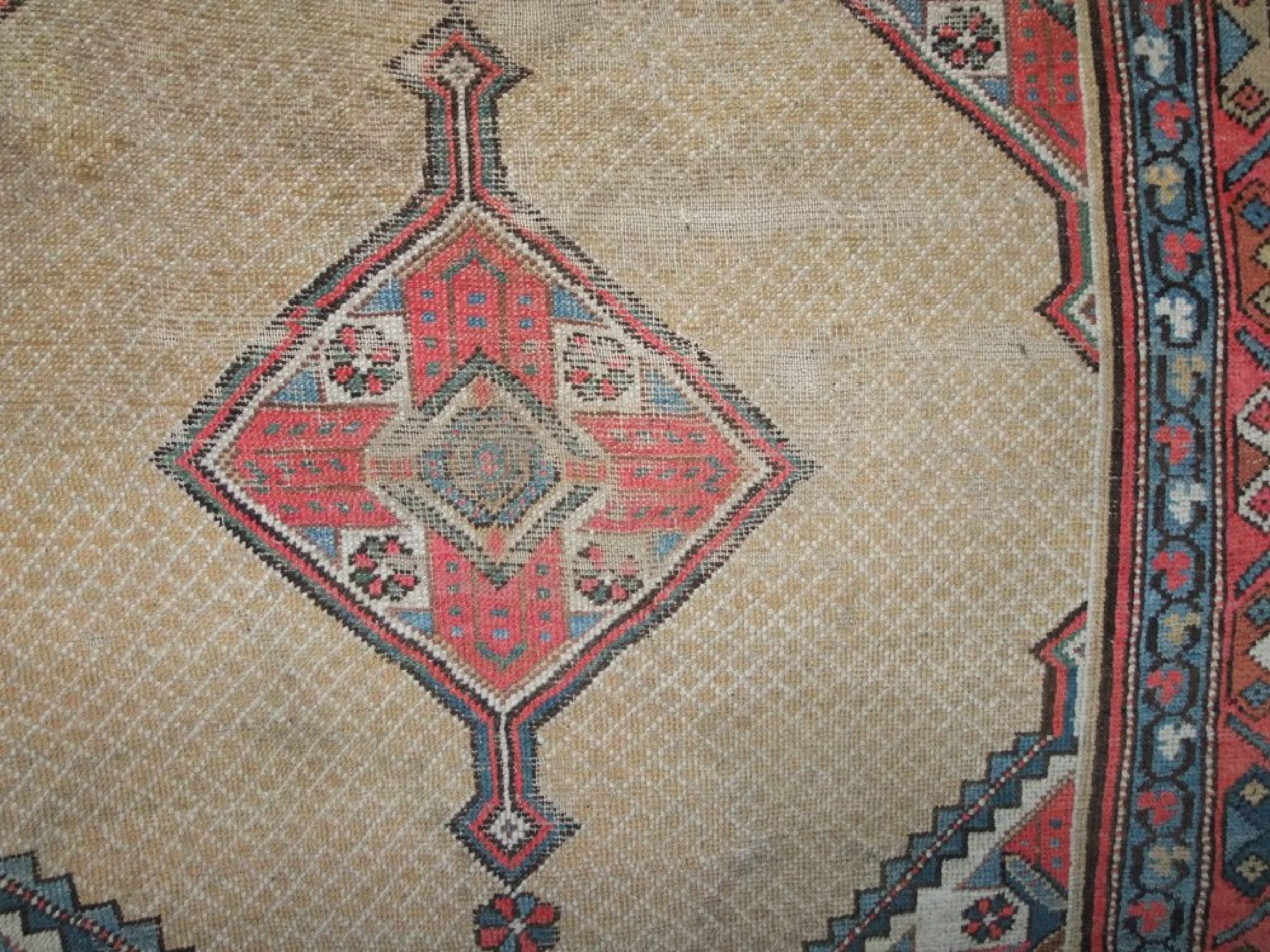 Appraisal: An eastern wool carpet with beige ground field supporting two