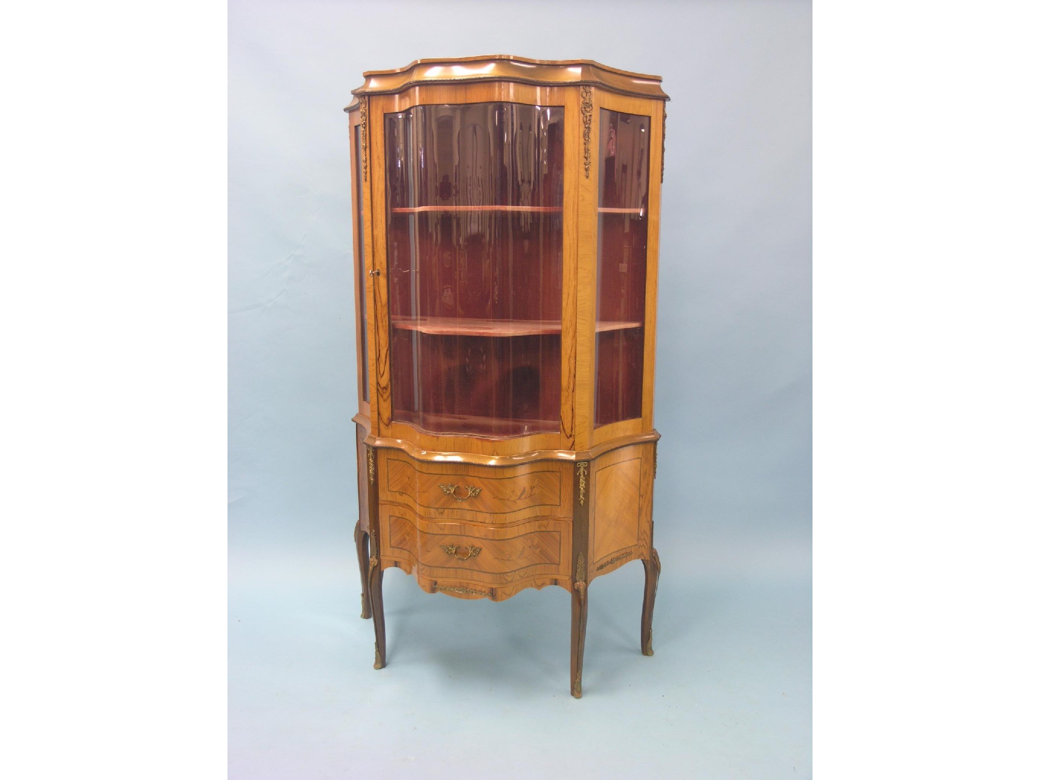 Appraisal: A Louis XV-style inlaid walnut vitrine serpentine-fronted with lined interior