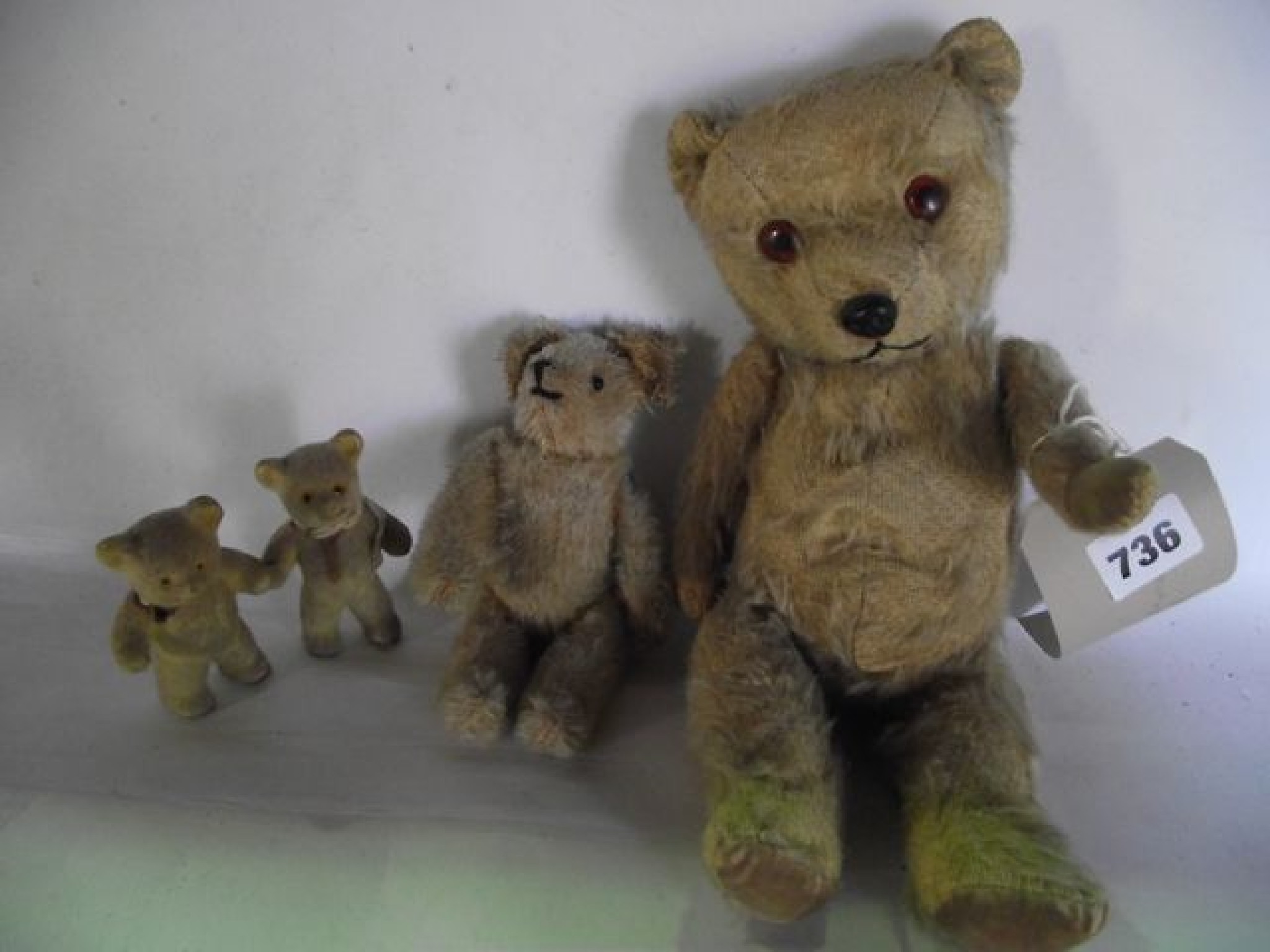 Appraisal: A small antique teddy bear with inset glass eyes together