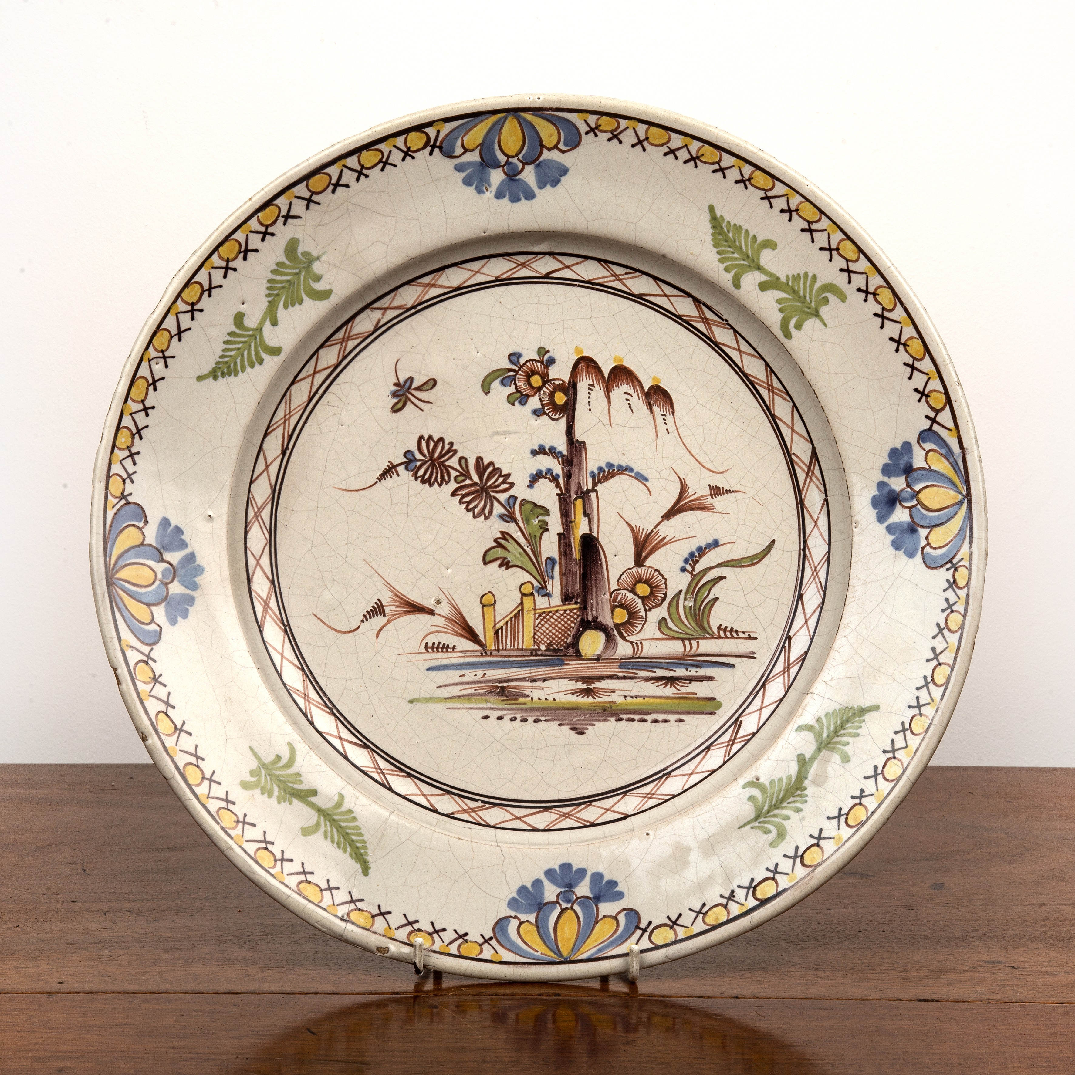 Appraisal: Lambeth delftware chargerpainted with a Chinese-style central foliate and fence