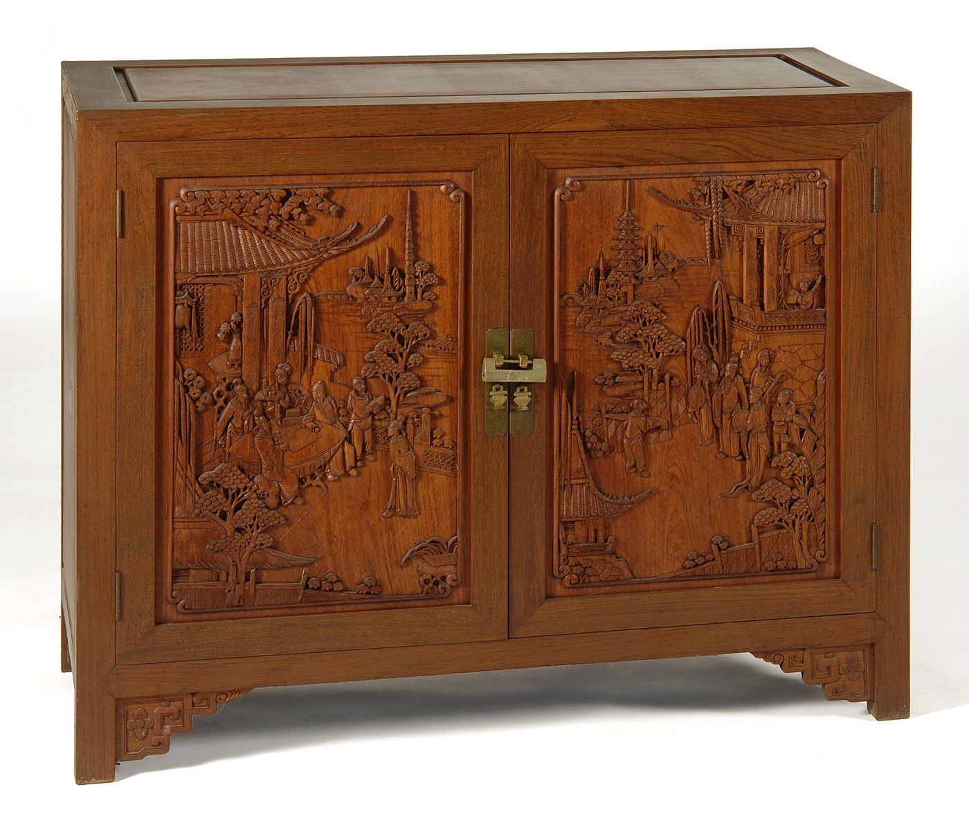 Appraisal: CHINESE-STYLE CARVED TWO-DOOR CABINET In mahogany with two cupboard doors