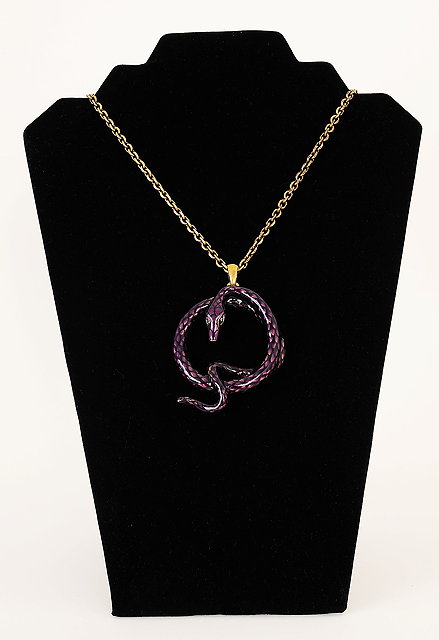 Appraisal: An Alexander McQueen necklace with a purple snake pendant on