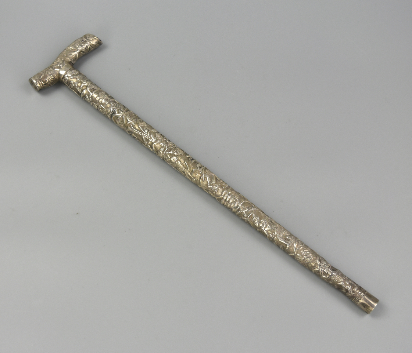 Appraisal: A SMALL ASIAN CARVED SILVER HANDSTICK TH C an small