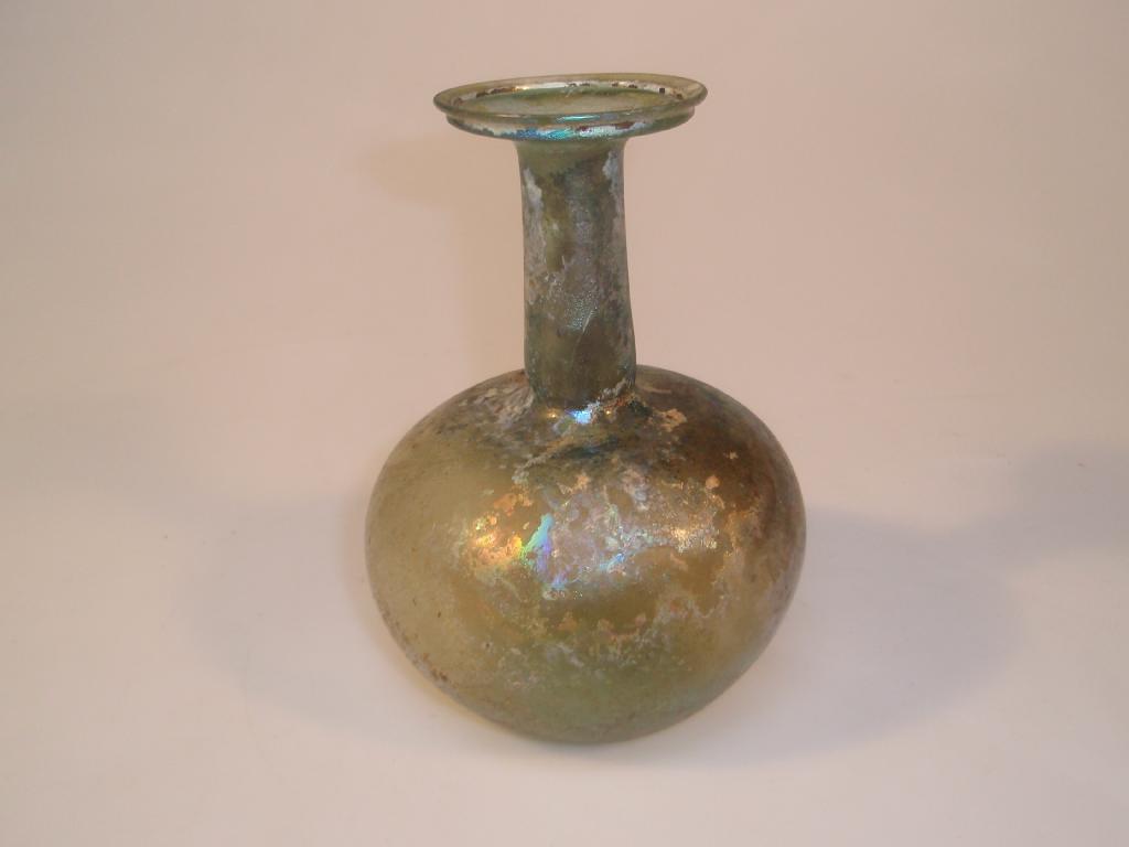 Appraisal: A bluish-green Roman glass flask the flaring mouth with a