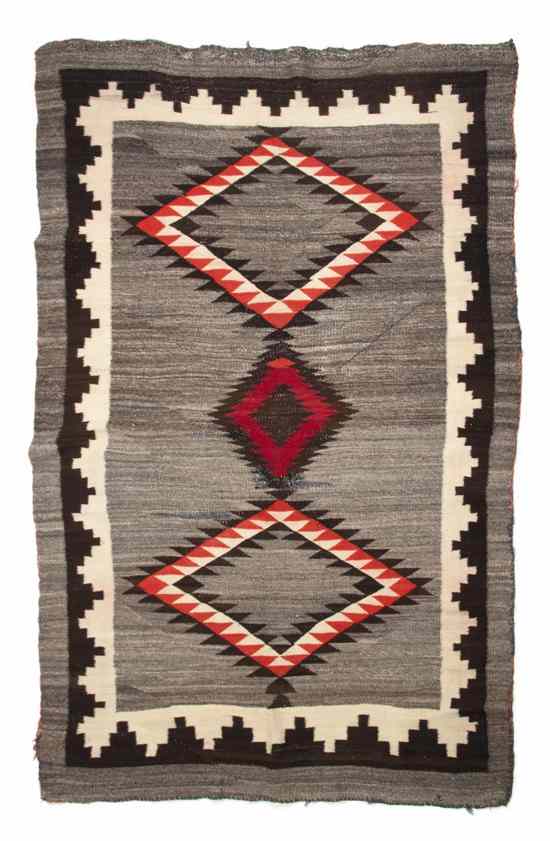 Appraisal: A Navajo Blanket having three diamonds with brown red and