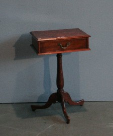 Appraisal: An occasional pedestal table in mahogany with a single drawer