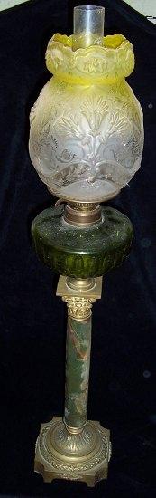 Appraisal: An Edwardian oil lamp the shaped etched glass shade over