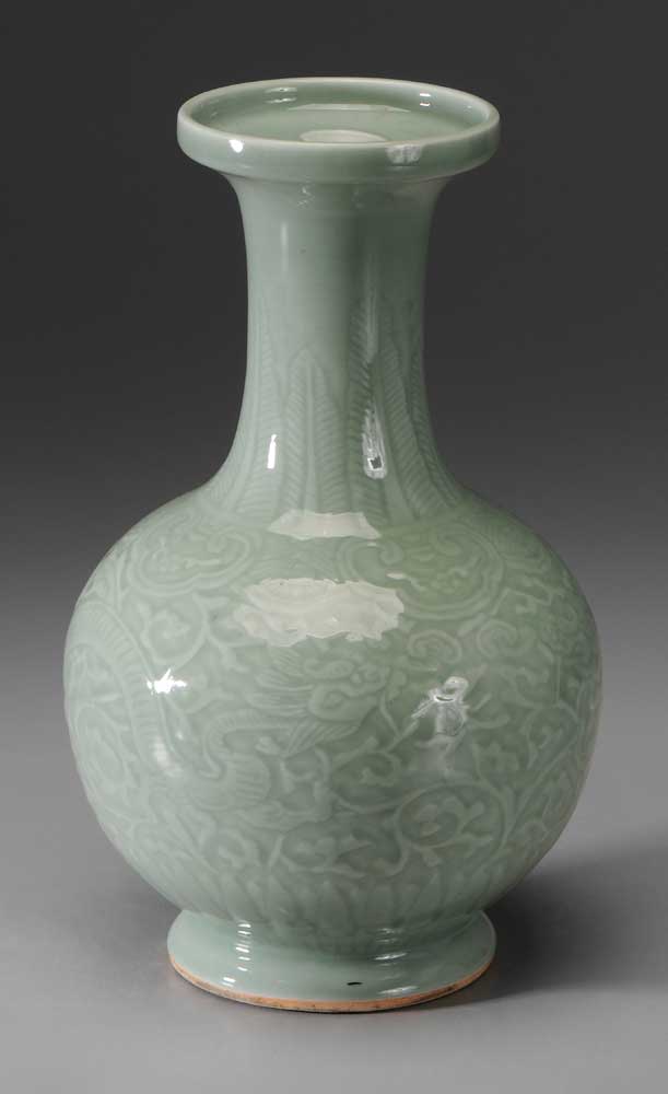 Appraisal: Celadon Porcelain Vase Chinese bottle form carved with dragons among