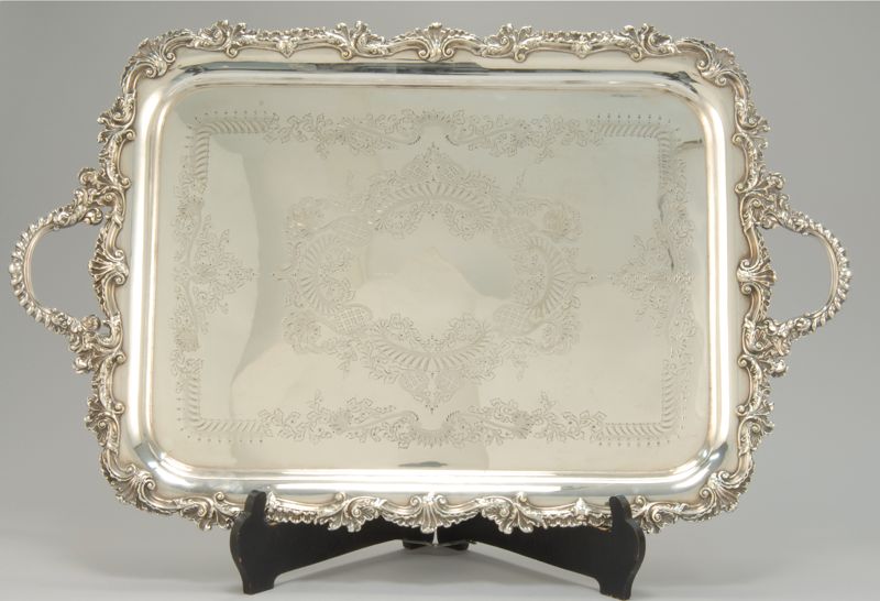 Appraisal: ELABORATE SILVER PLATED TWO-HANDLED SERVING TRAY With central decoration of