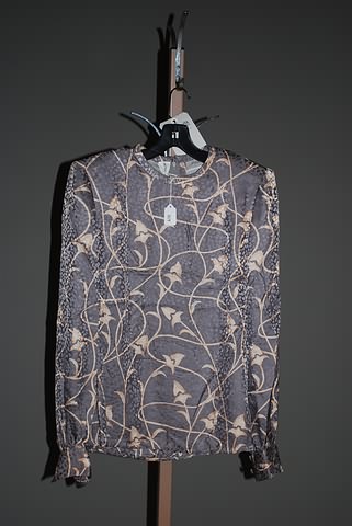 Appraisal: Andr LaugBlue long sleeve silk blouse with brown tones Approx