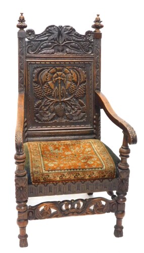 Appraisal: An oak Wainscot chair the panelled back heavily carved with