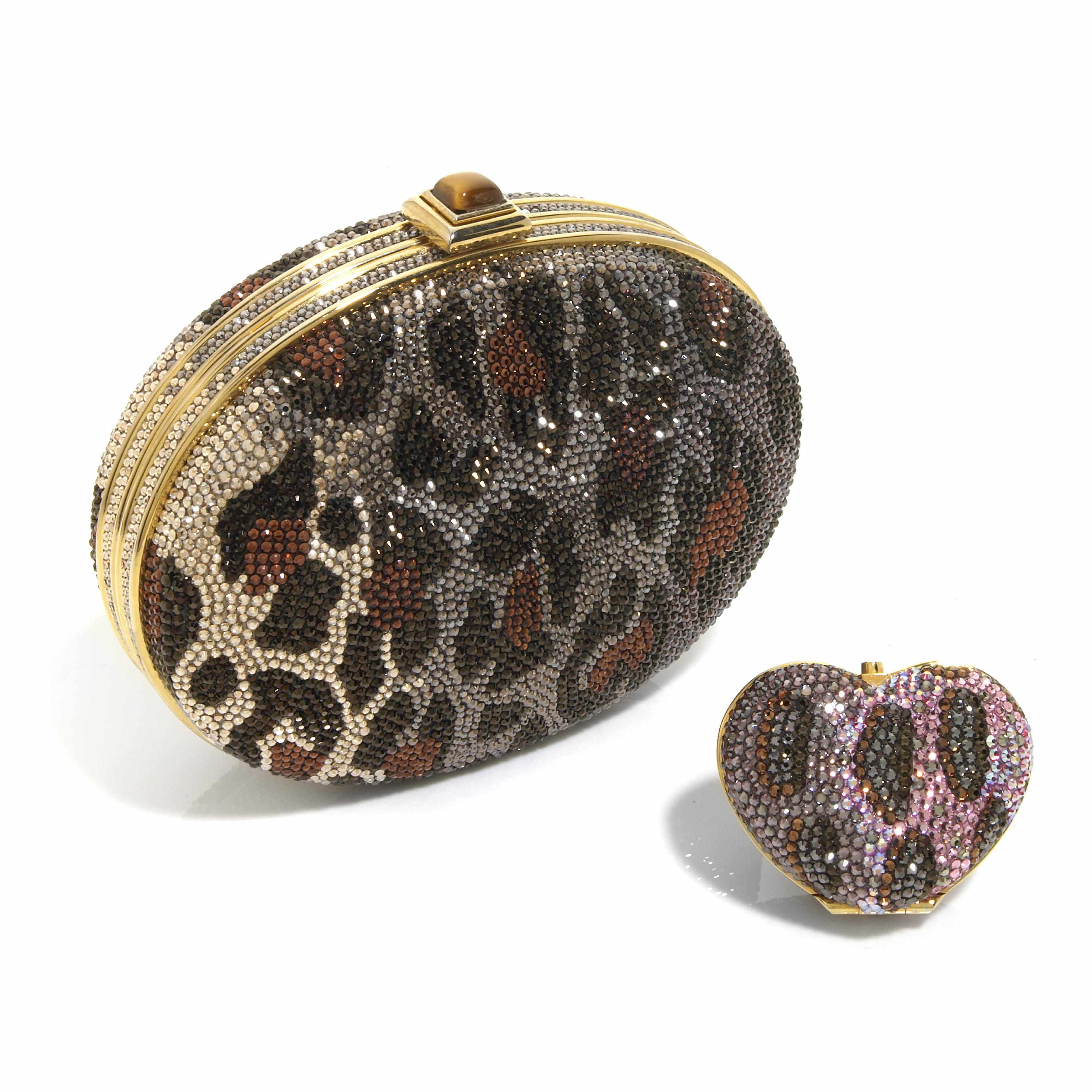 Appraisal: An oval-shaped multi-colored crystal leopard print purse with a tiger's