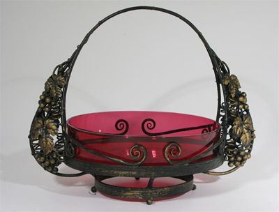 Appraisal: A patinated metal and cranberry glass centre piece in the