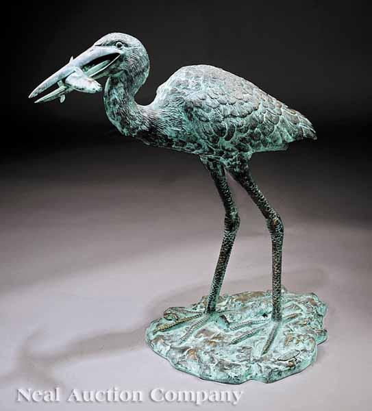 Appraisal: A Patinated Bronze Garden Sculpture of a Feeding Egret on