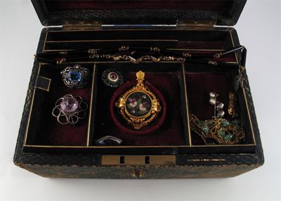 Appraisal: A jewellery box with two removable partitioned trays containing a