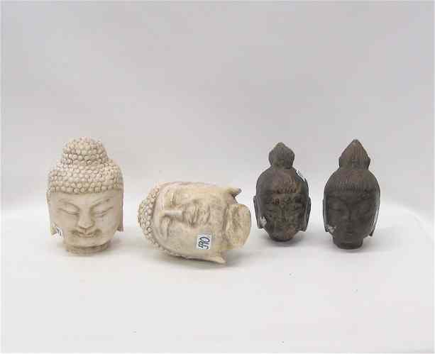 Appraisal: FOUR SCULPTED STONE BUDDHA HEADS two are white marble heights