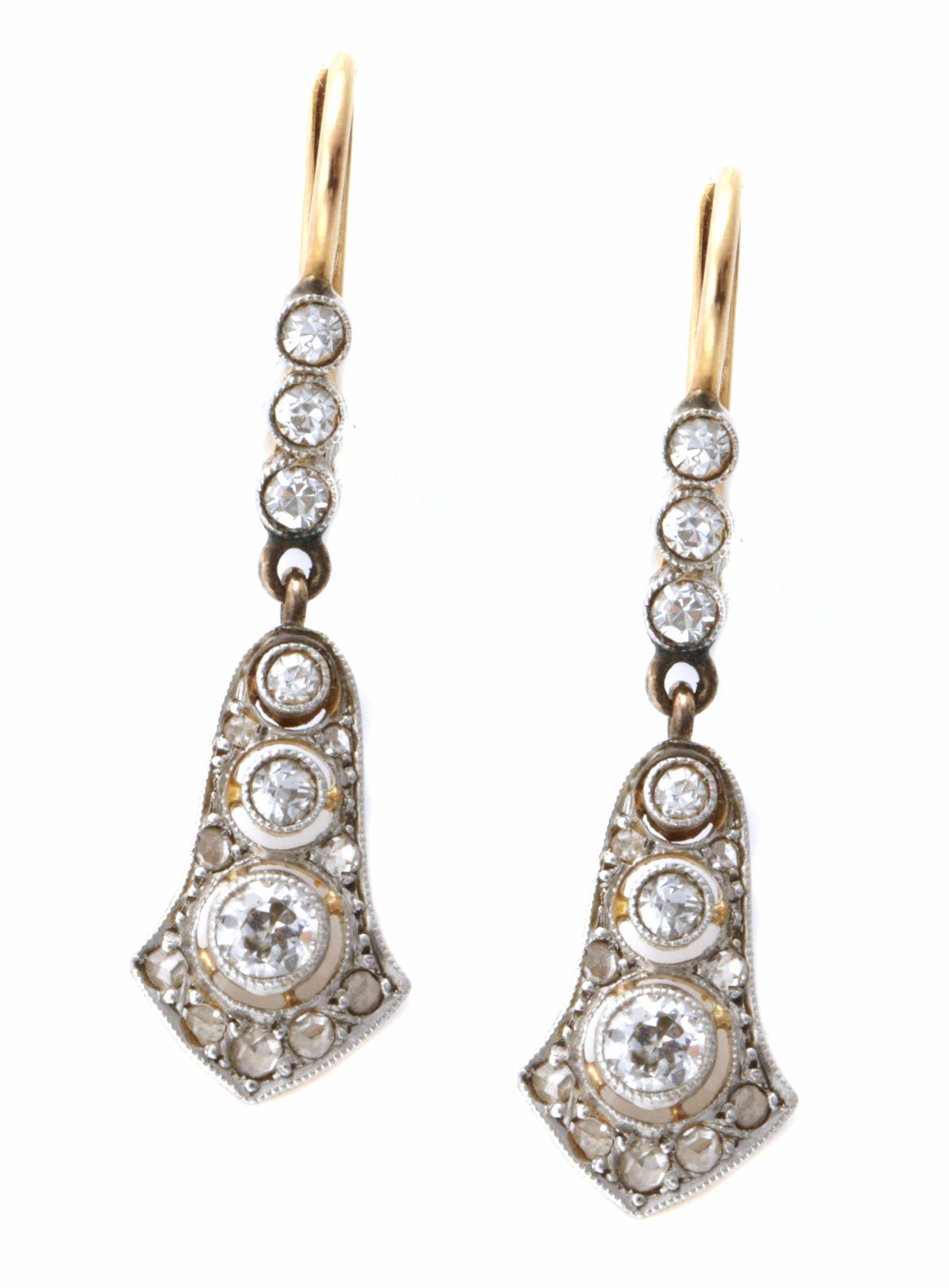 Appraisal: A pair of diamond and platinum-topped gold earrings featuring old