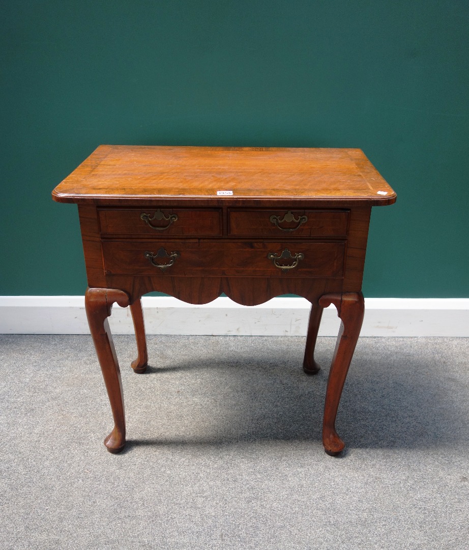 Appraisal: A mid th century crossbanded walnut lowboy with three drawers