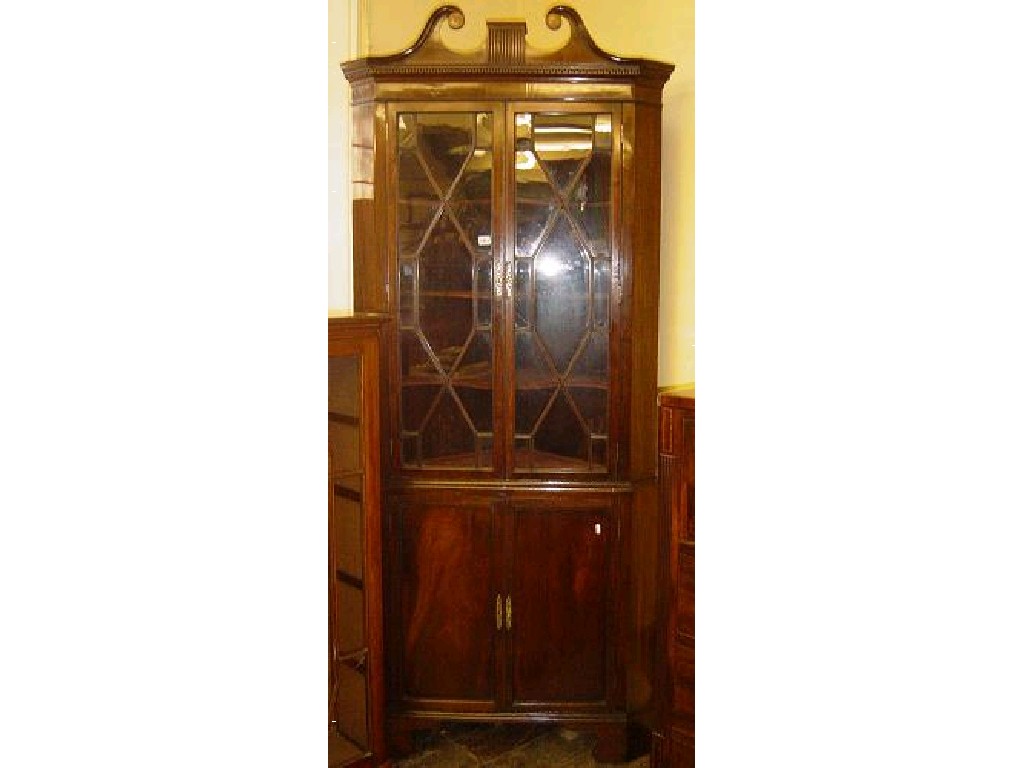 Appraisal: A Georgian mahogany freestanding corner cabinet with broken swan neck