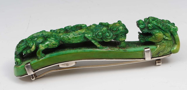 Appraisal: A Chinese green stained ivory belt buckle th Centurymounted now