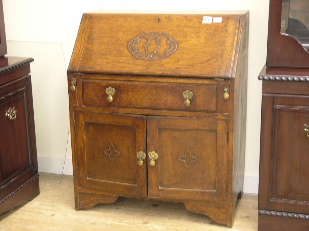 Appraisal: A solid oak bureau fall front above single drawer and