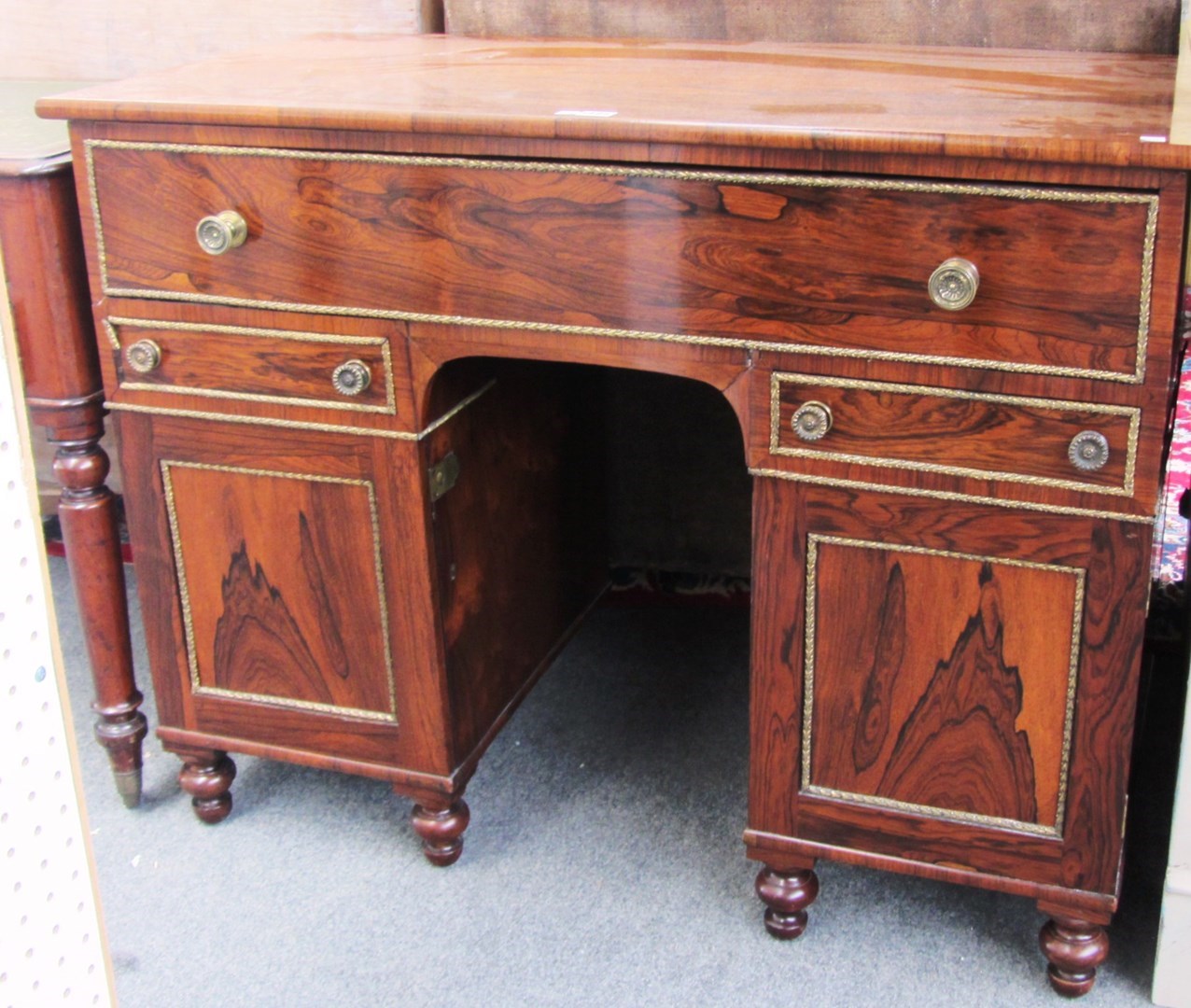 Appraisal: An early th century gilt metal mounted rosewood knee hole