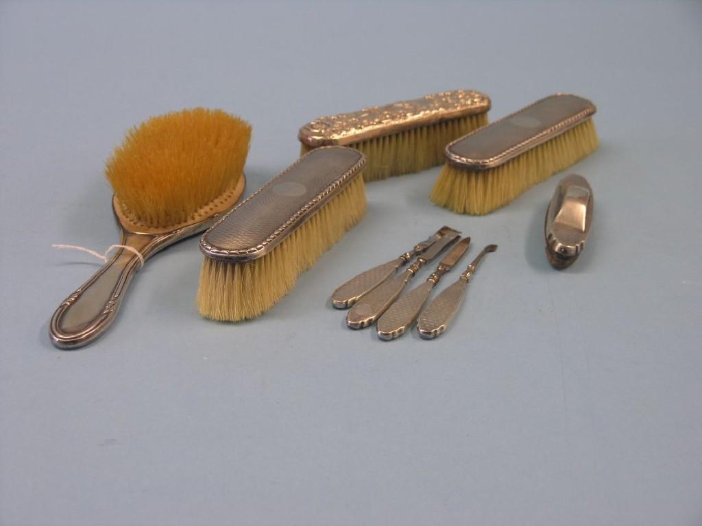 Appraisal: Silver dressing table utensils consisting of engine-turned nail buffer and