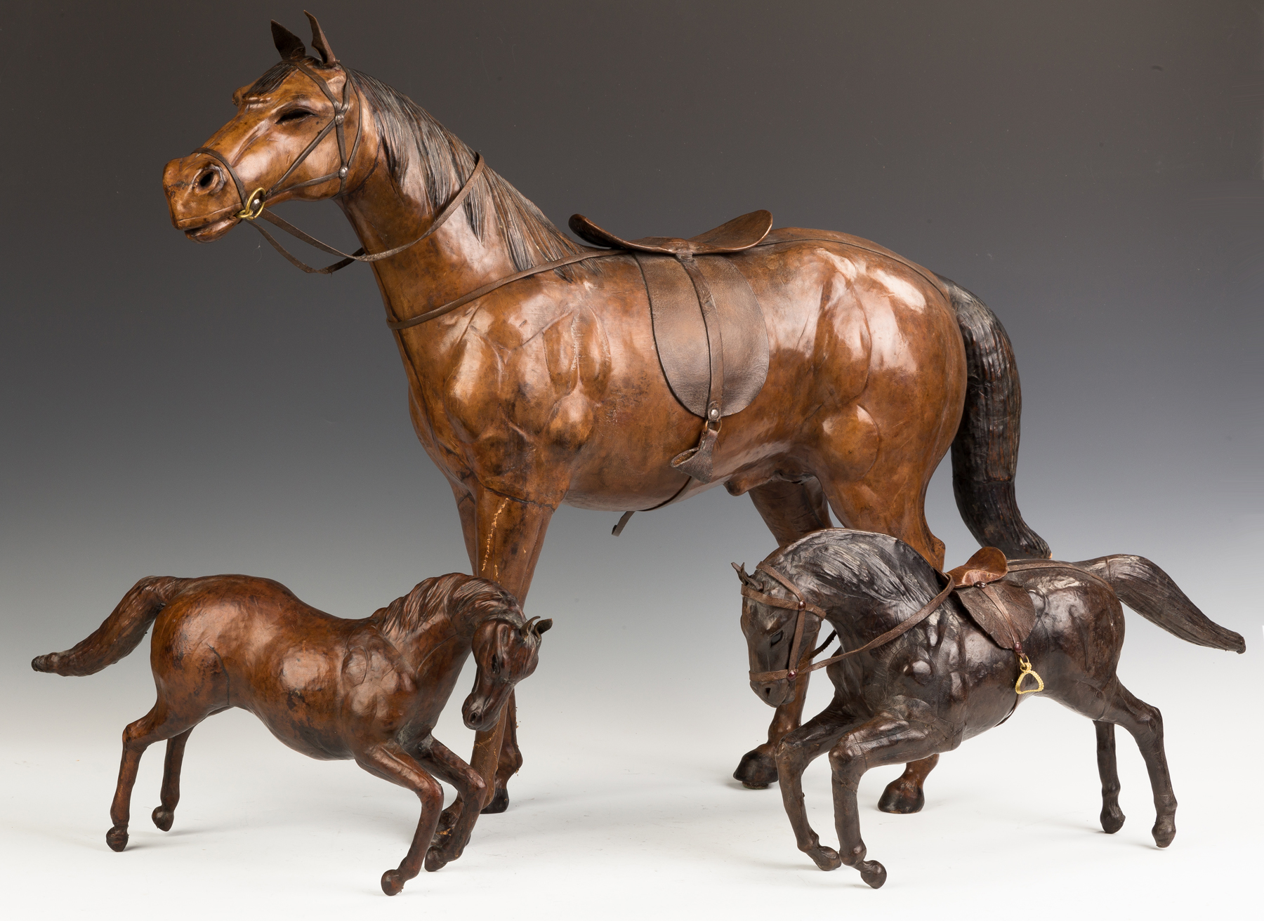 Appraisal: Three Molded and Leather Horses Mid- th century