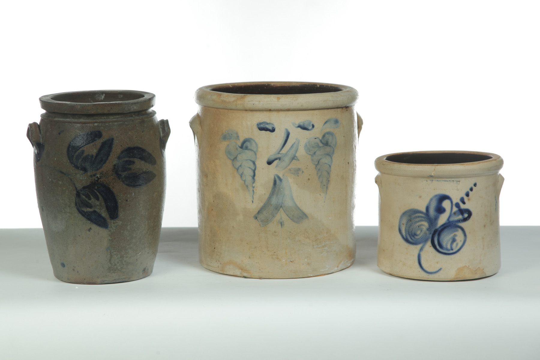 Appraisal: THREE STONEWARE JARS WITH HANDLES AND COBALT DECORATION American nd