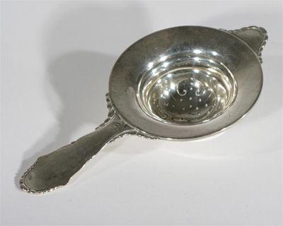 Appraisal: A Danish silver tea strainer in the style of Georg