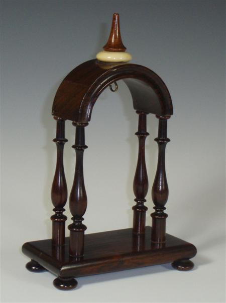 Appraisal: A Victorian rosewood watch stand the rounded arch surmounted by