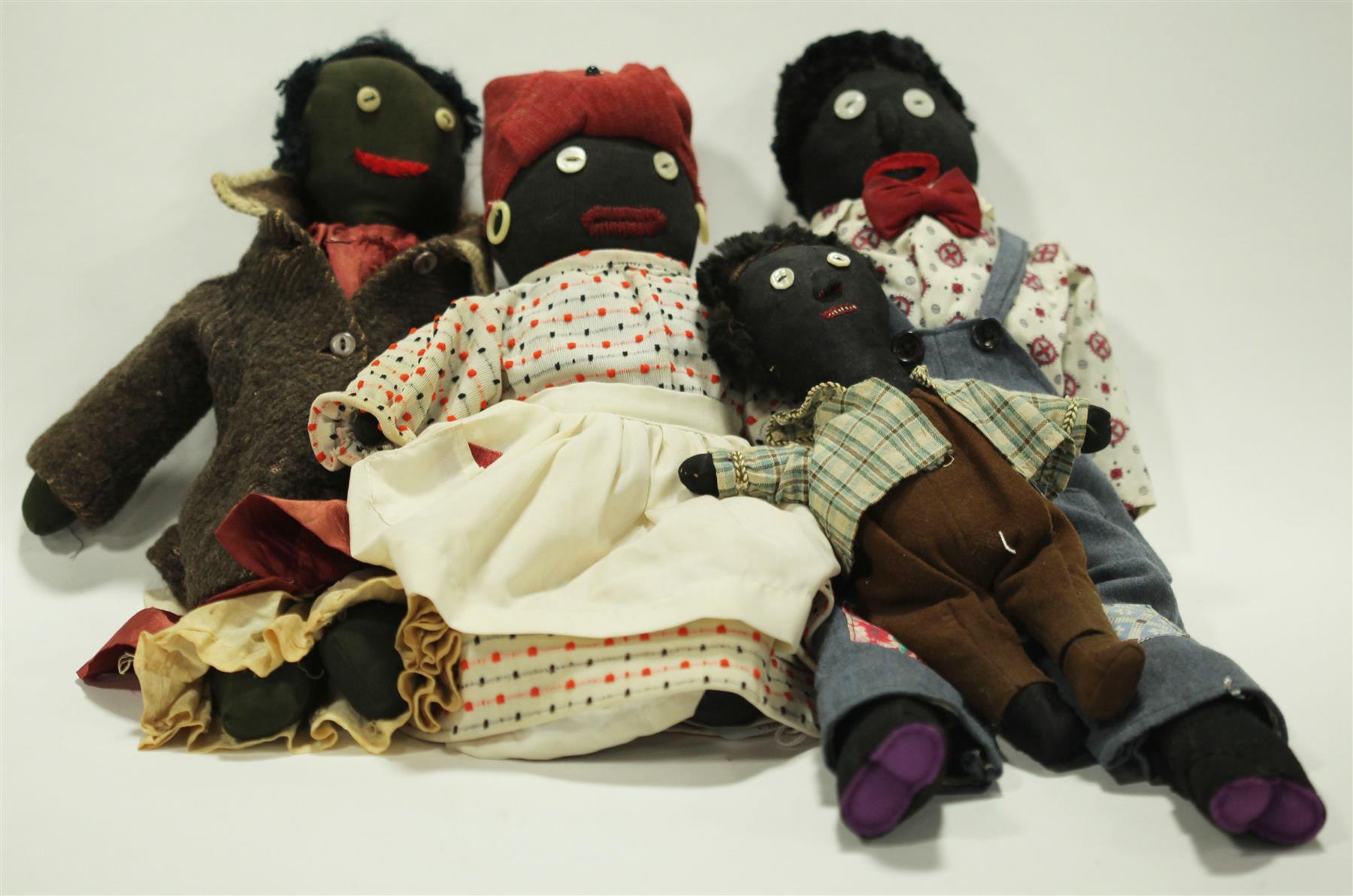 Appraisal: FOUR BLACK CLOTH DOLLS WITH BUTTON EYES Early th century