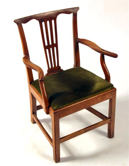 Appraisal: A George III elm country arm chair the shaped top-rail