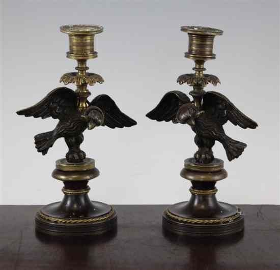 Appraisal: A pair of Regency bronze candlesticks modelled with an eagle