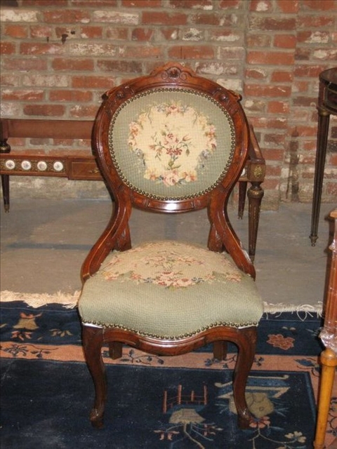 Appraisal: THREE VICTORIAN MAHOGANY NEEDLEPOINT CHAIRS Each with oval carved backs