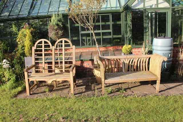 Appraisal: A PAIR OF TEAK GARDEN SEATS with horizontal backs and