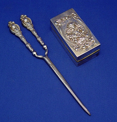 Appraisal: TURN OF THE CENTURY ENGLISH SILVER CURLING IRON Ornately embossed