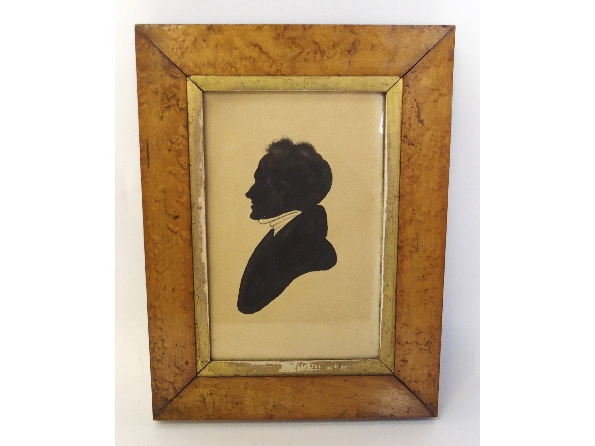 Appraisal: Black painted silhouette of a man in burr maple frame