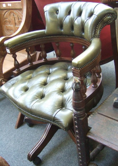 Appraisal: A th century stained beech office swivel chair with button